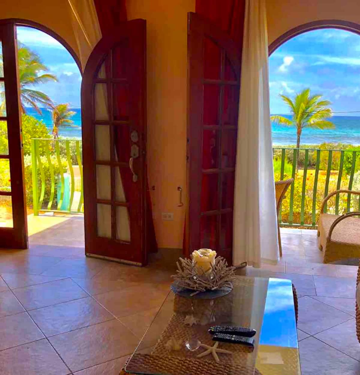 Twin wooden arches in the Lower apartment framing the sea